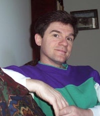 a man wearing a purple and green sweater