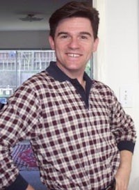 a man in a plaid shirt posing for a picture