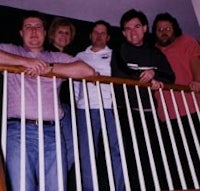 a group of people standing on a stair railing