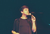 a man in a black shirt holding a microphone