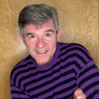 a man wearing a purple and black striped shirt