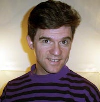 a man wearing a purple and black striped shirt